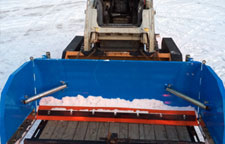 Snowplow easily loads on a trailer .